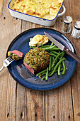 Filet mignon with herb crust and green beans