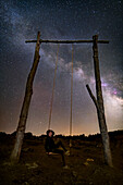 Milky Way over a man on a swing