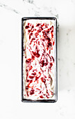 Ice cream dessert with summer berry puree in a box dish