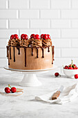 Chocolate drip cake with swirls and cherries