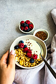 Healthy breakfast with ripe berries and yogurt served in the bowl