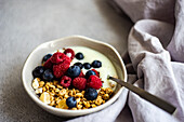 Healthy breakfast with ripe berries and yogurt served in the bowl