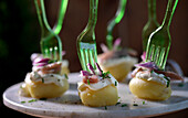 Herring tapas with crème fraiche, red onion and chives