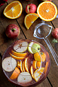 Christmas punch with slices of fruit in a glass punch bowl