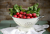 Radishes in white stand-up strainer