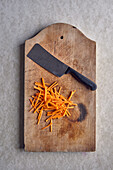 Carrots cut into julienne on wooden board