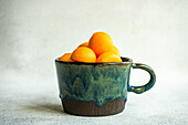 Balls of ripe cantaloupe melon in a ceramic cup