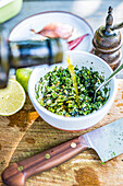 Prepare chimichurri - adding oil to the herbs
