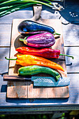 Summer vegetables with knife on wooden board