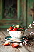 Fresh strawberries in vintage colander
