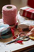 Red string and scissors with embroidery thread and box