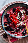 Antioxidant frozen fruit mousse bowl with blackberries, raspberries and coconut