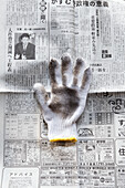 Work glove on a newspaper (Japan)