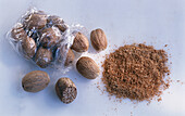 Cellophane bag with nutmeg and a heap of nutmeg powder