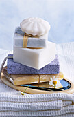 Still life with soaps, pumice stone, mirror and towels