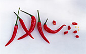 Red chilies and chili rings on a light background