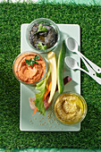 Three kinds of dips with vegetable sticks for game night snacks