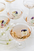 Sparkling rose wine with edible flower garnish