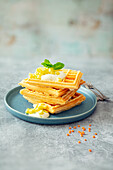 Gluten-free waffles made from red lentil flour with soy yogurt and pineapple salad