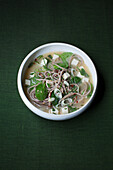 Vegan miso soup with soba noodles, tofu, and spinach