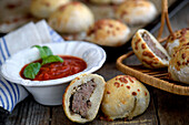 Buns filled with minced meat, served with tomato sauce