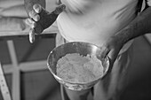 Baker holding a bowl of flour