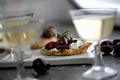 Rosemary crostini with cherries and goat cheese