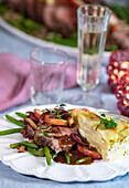 New Year's Eve menu - roast beef with apples, green beans, potato cake, and port wine sauce