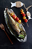 Baked mackerel with tomato skewers