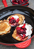 Pancakes with blackberry compote and cream
