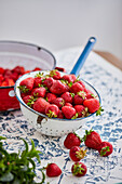 Fresh strawberries in a colander