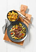 Lamb with pointed cabbage and potato wedges