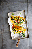 Colourful vegetable omelette with grainy cream cheese