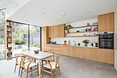 Light flooded living room with oak kitchen and dining area