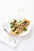 Puff pastry tart with spring onions wrapped in bacon and prawns