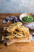 Homemade fish and chips on a wooden board
