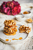 Pine Nut Caramel biscuits on a white ceramic plate