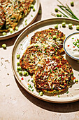 Zucchini pancakes with peas, chives, parmesan, and dip