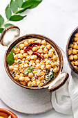 Southindian Chickpeas salad garnished with coconut, curry leaves and dried red chilli