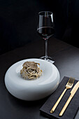 Appetizing pasta with sauce and tasty black truffles served on white round plate