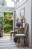 Carved wooden lamps on console in conservatory