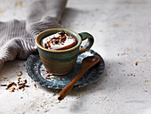 Coffee with cocoa, whipped cream, and nuts