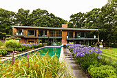 Flowerbeds around the pool in the garden around luxurious architect's house