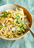 Spaghetti with zucchini sauce, chilies, basil, and Parmesan cheese