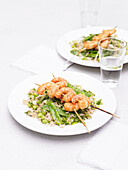 Miso shrimp skewers on rice salad with vegetables