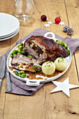 Stuffed pork rib with potato dumplings and Brussels sprouts for Christmas