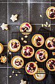 Christmas blueberry and honeyed cream cheese mini tarts with toasted almond flakes