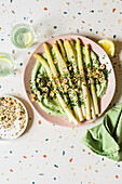 White asparagus with spinach whipped feta, topped with roasted seed, spice and hazelnut mix