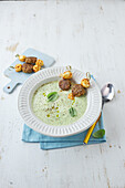 Courgette herb soup with veggie meatballs