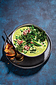 Creamy soup with broccoli, peas, and ham